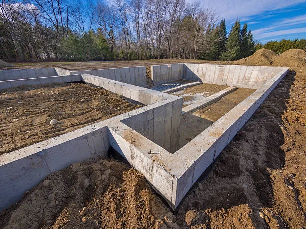 Freshly poured concrete foundation ready for framing